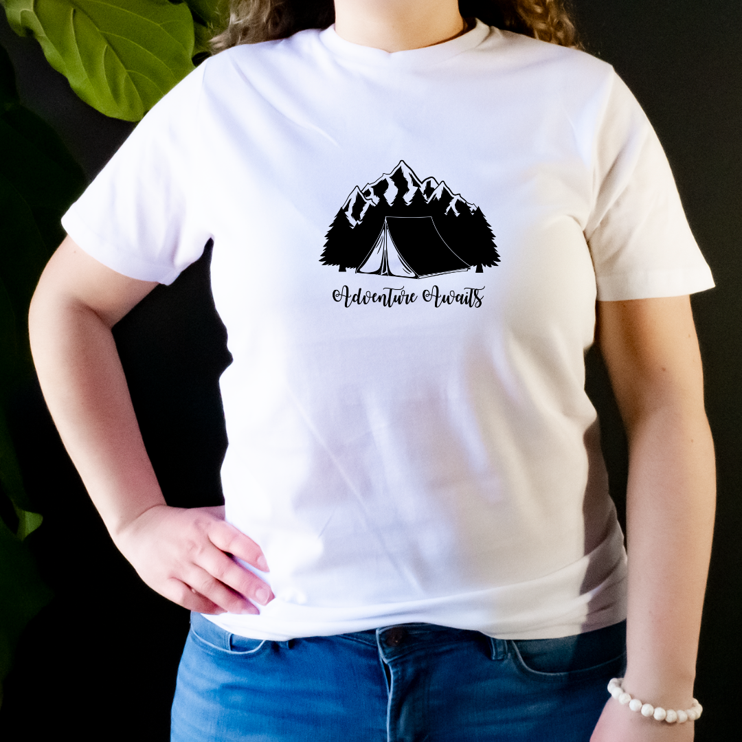 "The shirt features a design of a camping scene; a cozy tent sits in the middle of a forest, surrounded by trees and a mountain range in the distance. We want to capture the adventurous spirit and love for the great outdoors that camping lovers feel".