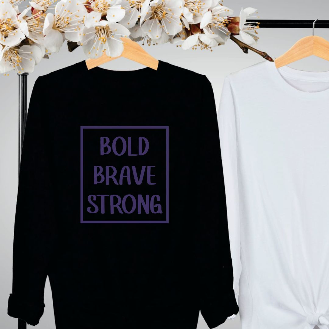 "Bold, brave, strong text design centered on black long sleeve shirt."