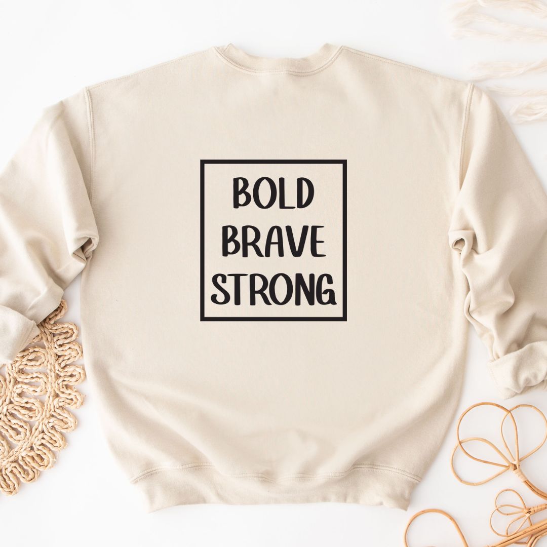 "Bold, brave, strong text design centered on natural sweater."